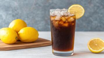 A glass of iced tea with ice and lemons photo