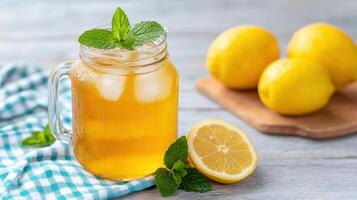A jar of lemonade with mint leaves and lemons photo
