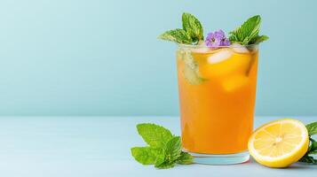 A glass of orange juice with mint leaves and lemon photo