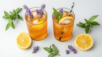 Two glasses of lemonade with mint leaves and lemons photo
