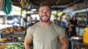 A man standing in front of a produce stand photo