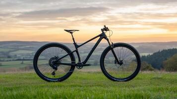 A mountain bike is parked on a grassy hill photo