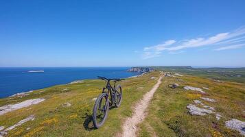 A bike on the edge of a cliff overlooking the ocean photo