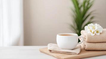 serene tea setup with cup, soft towels, and flower, perfect for relaxation photo
