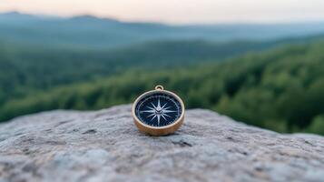 A compass on a rock in the mountains photo