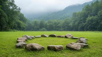 A circle of rocks in a field photo
