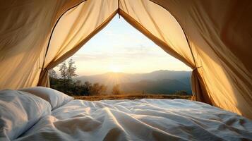 A bed in a tent with a view of mountains photo