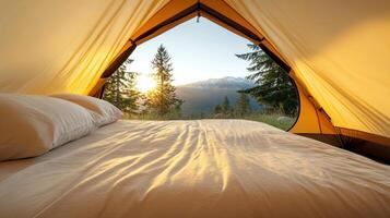 A bed inside a tent with a view of the mountains photo