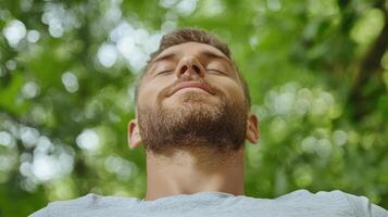 A man is looking up at the sky with his eyes closed photo