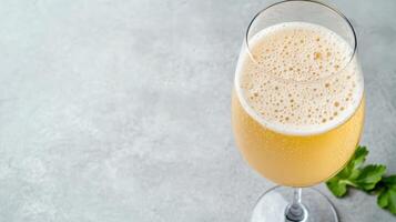 A glass of champagne with a slice of lemon photo
