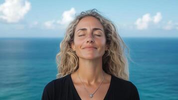 A woman with her eyes closed and her hands on her head photo