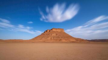 A desert landscape with a mountain in the distance photo