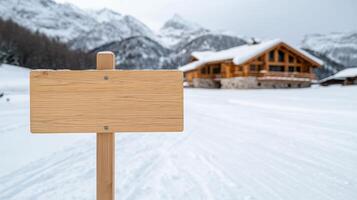 A wooden sign is in the snow near a cabin photo