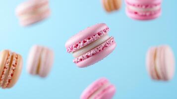 Delicate macarons in soft colors float against light blue background, creating whimsical scene photo