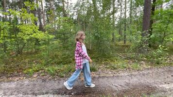 Young girl walking on a path in the forest video