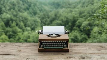 A typewriter on a wooden table in front of a green forest photo
