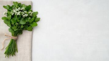 Bouquet of fresh mint on a linen cloth on a white background photo