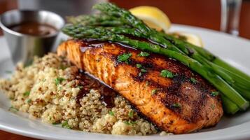 A plate of food with salmon, asparagus and couscous photo