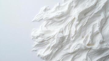 A pile of white whipped cream on a white surface photo