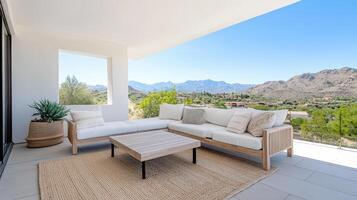A patio with white furniture and a view of mountains photo