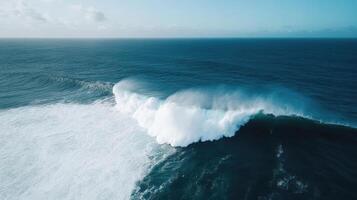 An aerial view of a large wave breaking on the ocean photo