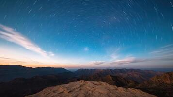 The night sky over the mountains with star trails photo