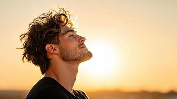 A man is looking up at the sun photo