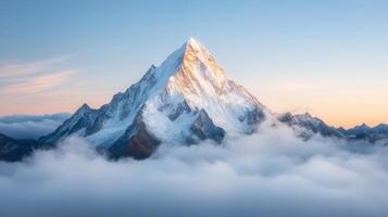 A mountain is seen in the clouds with a sun rising photo