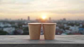 Two paper cups on a wooden table with a city in the background photo
