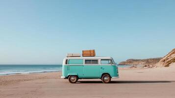 A blue vw bus with luggage on top of it sitting on the beach photo