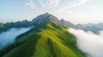 A mountain range with green grass and clouds photo