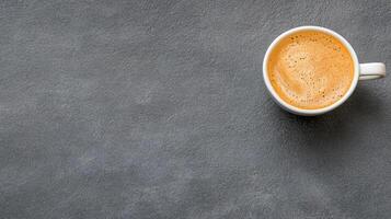 A cup of coffee on a dark surface photo