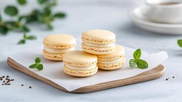 Macarons on a wooden tray with a cup of tea photo