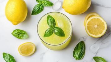 Lemonade with basil leaves and lemons on a white background photo
