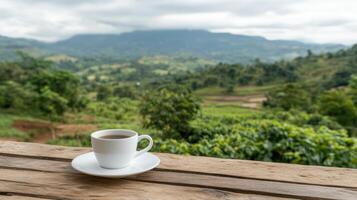 Coffee cup on wooden table with mountains in background photo