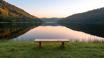A wooden bench sitting in front of a lake photo