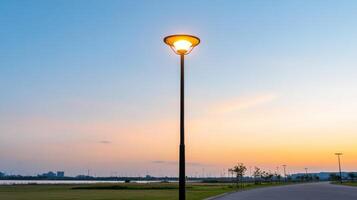 A street light is lit up at sunset photo