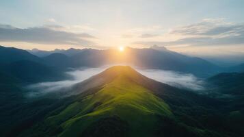 A view of the sun rising over a mountain range photo
