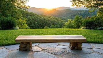 A bench sitting on a stone patio overlooking a valley photo