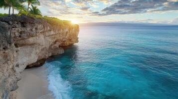 A beautiful beach with palm trees and a cliff at sunset photo