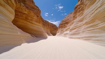 A white sand canyon with blue sky and clouds photo