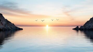 A sunset over the ocean with birds flying over it photo