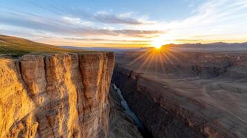 The sun rises over a canyon in the mountains photo