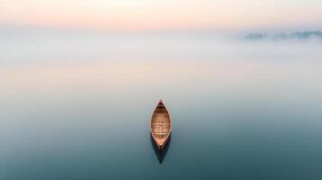 A boat floating on a calm lake at sunrise photo