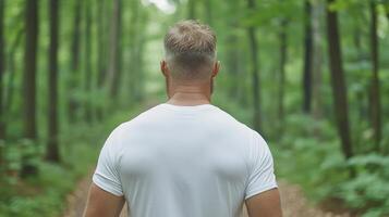 A man walking through a forest photo