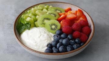 A bowl of fruit with yogurt and berries photo