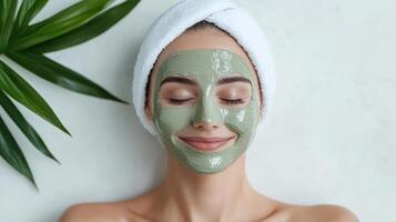 A woman with a green clay mask on her face photo