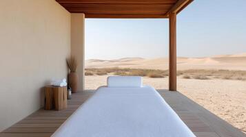 A massage bed in the desert with sand dunes in the background photo