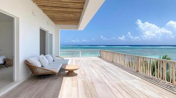 A balcony with white furniture overlooking the ocean photo