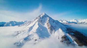 Aerial view of snow covered mountain peaks photo